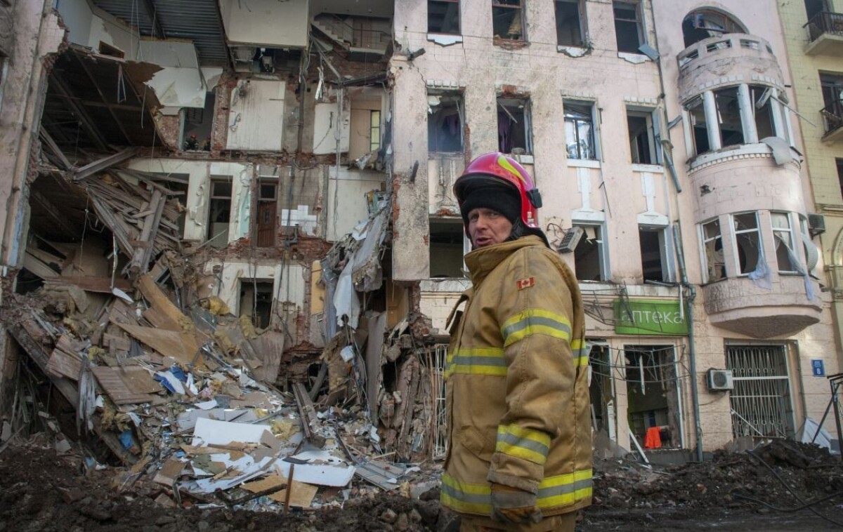 Hasič pracuje na zničenej budove v Charkove