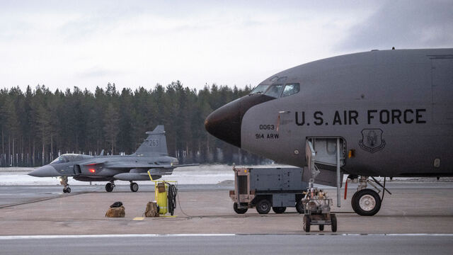 JAS 39 Gripen C/D fighter jet, left, passes a US KC-135 Stratotanker, a US military tanker aircraft, during military exercise Nordic Response at Luleå-Kallax Airport near Luleå